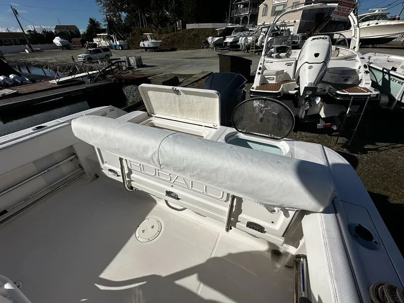 Slide: The Image of 2021 Robalo R242 Center Console boat interior with seating and storage. - 4