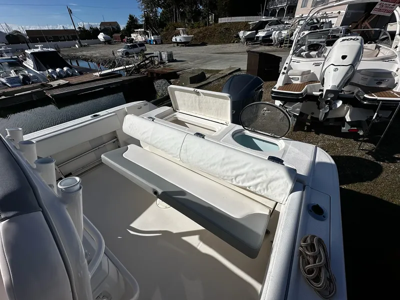 Slide: The Image of 2021 Robalo R242 Center Console boat interior with seating and storage. - 5