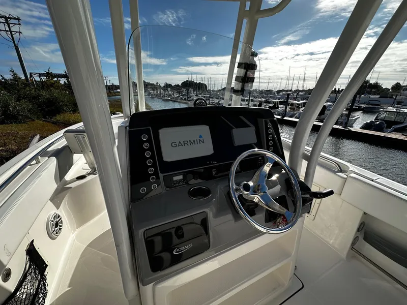 Slide: The Image of 2021 Robalo R242 Center Console boat with Garmin navigation, docked at marina. - 7