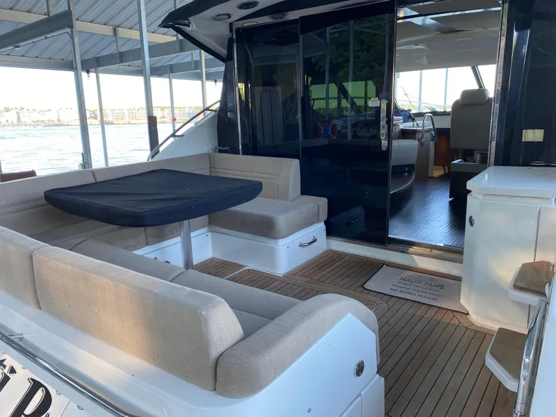 Slide: The Image of 2015 Sea Ray 510 Sundancer yacht with spacious outdoor seating and elegant interior. - 20