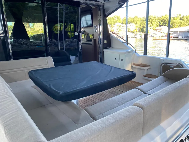Slide: The Image of Luxurious 2015 Sea Ray 510 Sundancer yacht interior with spacious seating and table. - 21