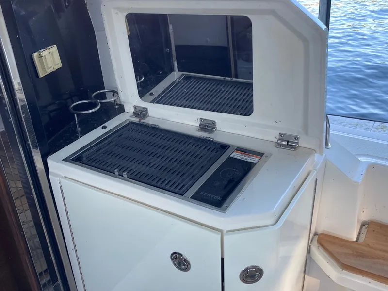 Slide: The Image of Outdoor grill on 2015 Sea Ray 510 Sundancer yacht, near water. - 23