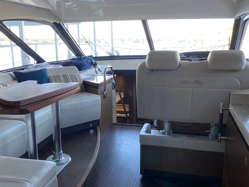 Slide: The Image of Interior of 2015 Sea Ray 510 Sundancer yacht with luxurious seating and panoramic windows. - 25