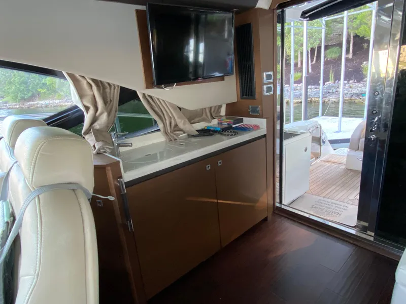 Slide: The Image of Interior of 2015 Sea Ray 510 Sundancer yacht with TV and kitchenette. - 29