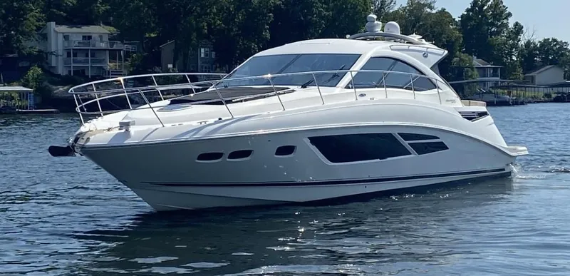 Slide: The Image of 2015 Sea Ray 510 Sundancer yacht cruising on a serene lake. - 3