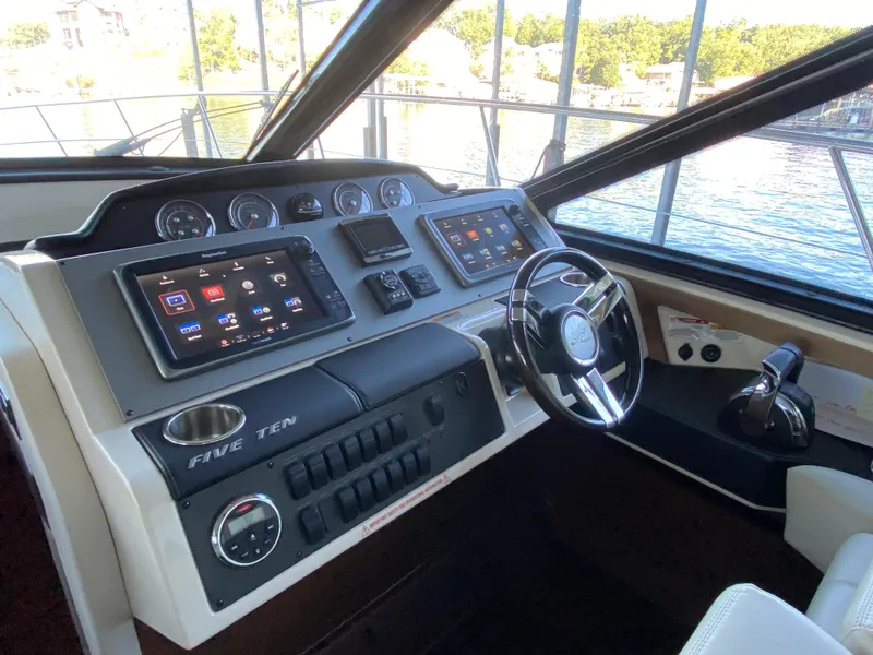 Slide: The Image of 2015 Sea Ray 510 Sundancer helm with modern navigation displays and controls. - 31