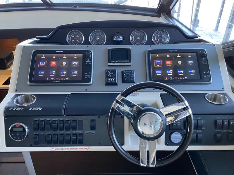 Slide: The Image of 2015 Sea Ray 510 Sundancer helm with dual navigation screens and modern controls. - 32