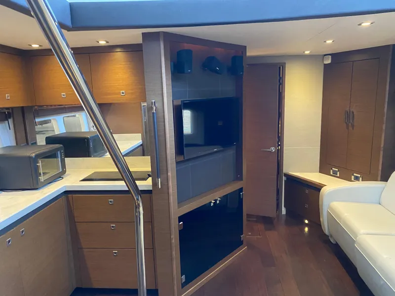 Slide: The Image of Luxurious interior of 2015 Sea Ray 510 Sundancer yacht with modern kitchen and seating area. - 35
