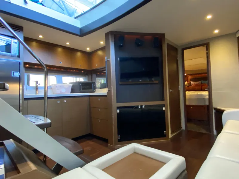 Slide: The Image of Luxurious interior of 2015 Sea Ray 510 Sundancer yacht with modern kitchen and entertainment area. - 36