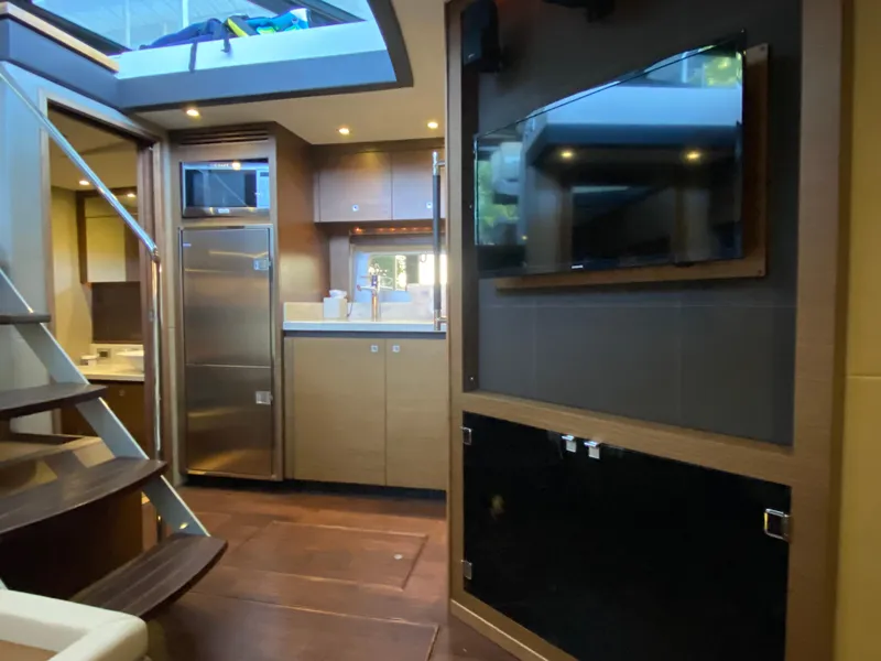 Slide: The Image of Luxurious interior of 2015 Sea Ray 510 Sundancer yacht with modern kitchen and entertainment area. - 37