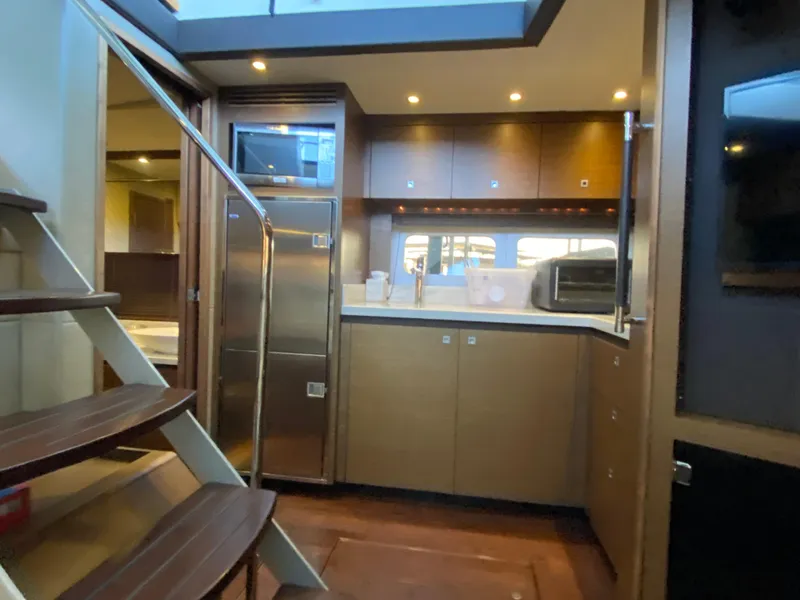 Slide: The Image of Luxurious 2015 Sea Ray 510 Sundancer yacht interior with modern kitchen and staircase. - 38