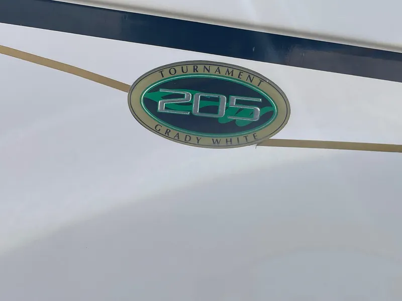 Slide: The Image of 2008 Grady-White Tournament 205 boat emblem on white surface. - 12
