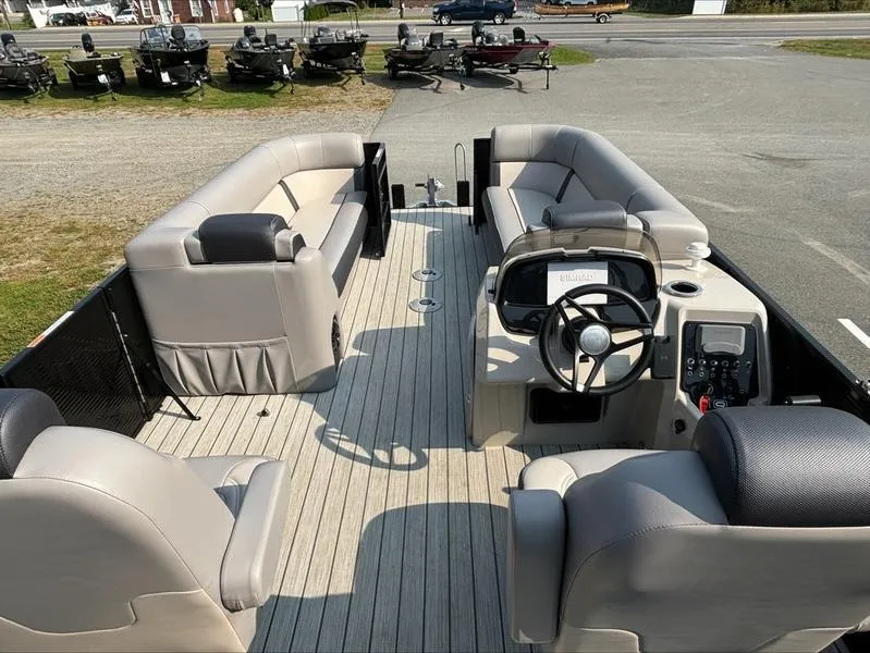 Slide: The Image of 2023 Princecraft QUORUM Q25 pontoon boat interior with plush seating and modern steering console. - 10