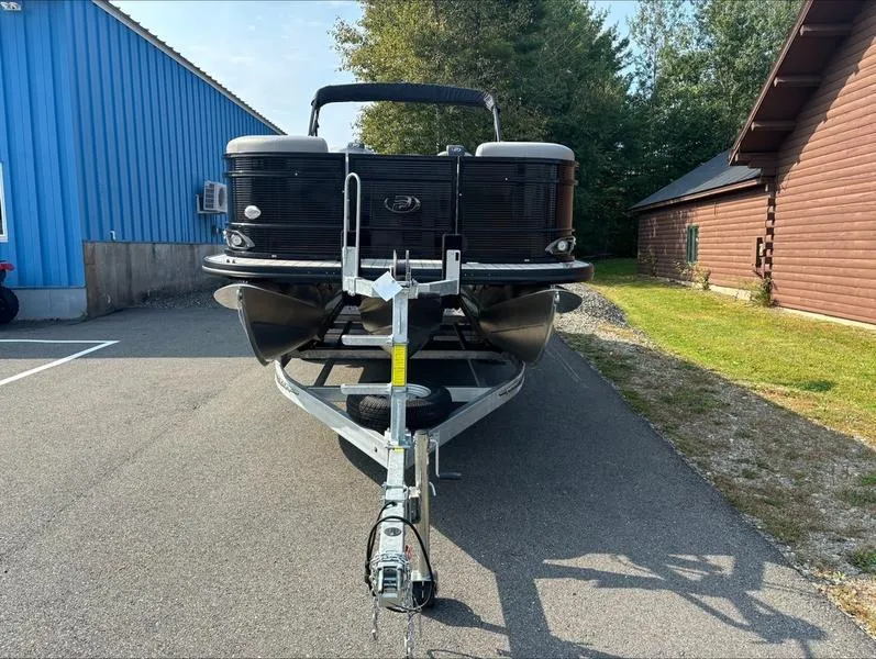 Slide: The Image of 2023 Princecraft QUORUM Q25 pontoon boat on trailer, parked outdoors. - 12