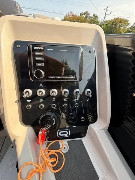 Slide: The Image of 2023 Princecraft QUORUM Q25 boat control panel with audio system and switches. - 6