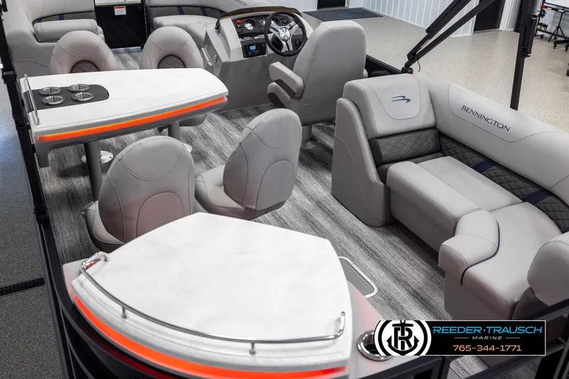Slide: The Image of 2025 Bennington 23 SXPDSE pontoon boat interior with plush seating and modern dashboard. - 11