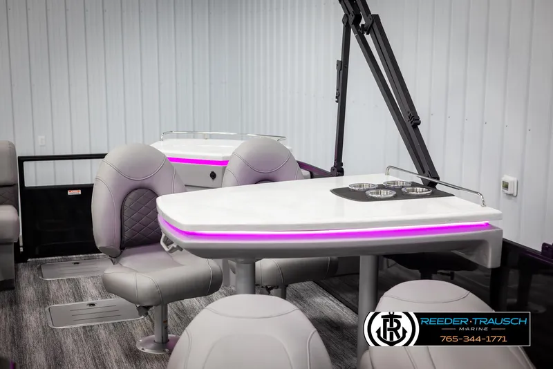Slide: The Image of 2025 Bennington 23 SXPDSE boat interior with modern seating and illuminated table. - 20