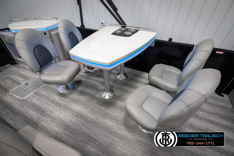 Slide: The Image of 2025 Bennington 23 SXPDSE boat interior with modern seating and table setup. - 22