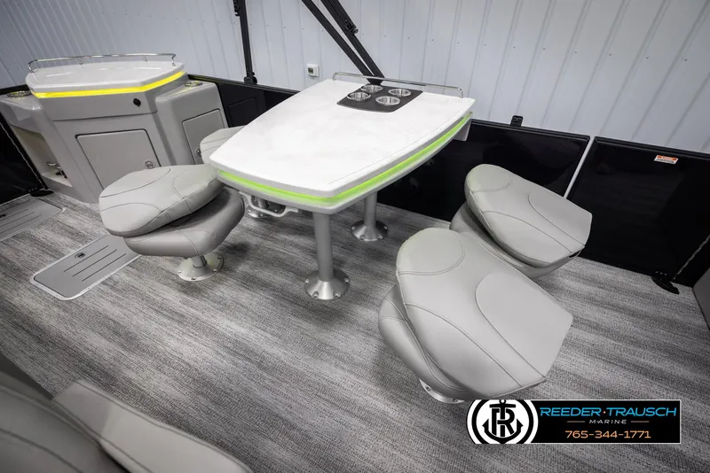 Slide: The Image of Interior of 2025 Bennington 23 SXPDSE pontoon boat with modern seating and table setup. - 23