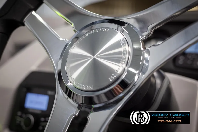 Slide: The Image of Close-up of 2025 Bennington 23 SXPDSE steering wheel with Reeder-Trausch Marine logo. - 28