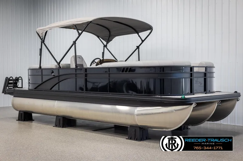 Slide: The Image of 2025 Bennington 23 SXPDSE pontoon boat with canopy in showroom setting. - 3