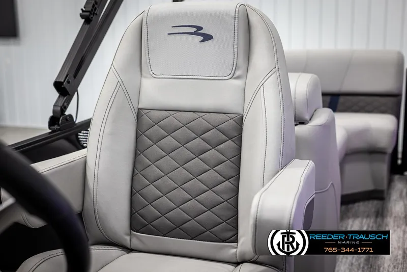 Slide: The Image of 2025 Bennington 23 SXPDSE boat seat with quilted design and logo, Reeder-Trausch Marine branding. - 36