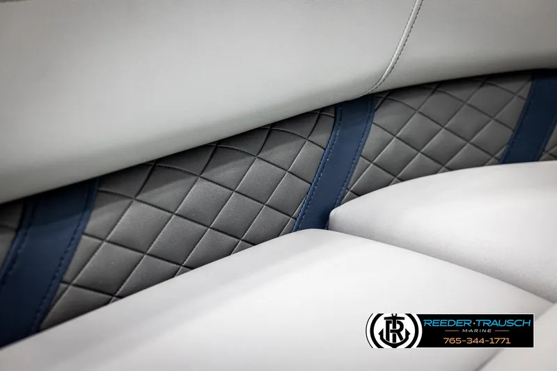 Slide: The Image of 2025 Bennington 23 SXPDSE boat interior with quilted upholstery and blue accents. - 39