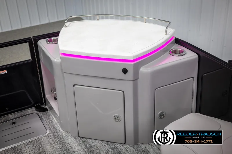 Slide: The Image of 2025 Bennington 23 SXPDSE boat interior with illuminated bar and storage compartments. - 42