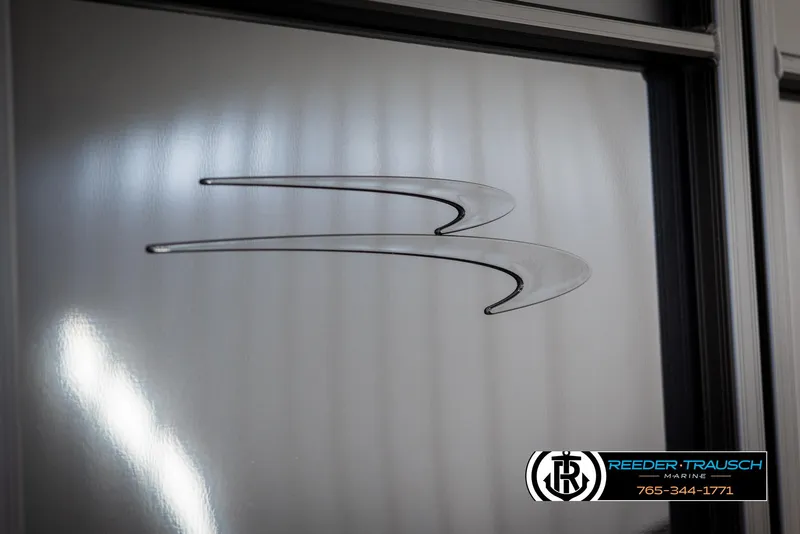 Slide: The Image of 2025 Bennington 23 SXPDSE logo on sleek metallic surface, Reeder-Trausch Marine branding. - 48