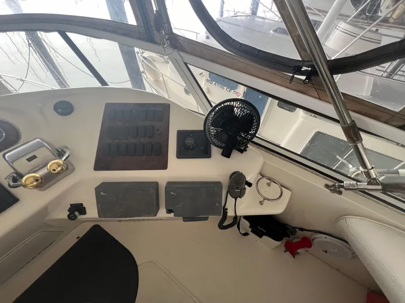 Slide: The Image of 2000 Sea Ray 380 Aft Cabin helm with controls, fan, and navigation equipment. - 10