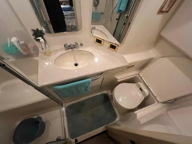 Slide: The Image of Bathroom interior of 2000 Sea Ray 380 Aft Cabin yacht, featuring sink and toilet. - 18