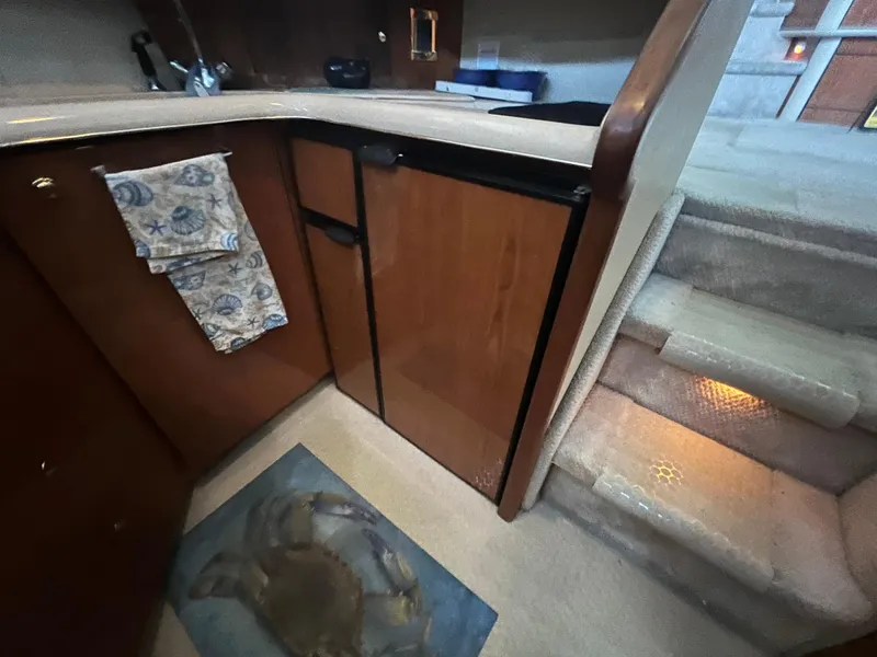 Slide: The Image of 2000 Sea Ray 380 Aft Cabin interior with kitchenette and carpeted stairs. - 21