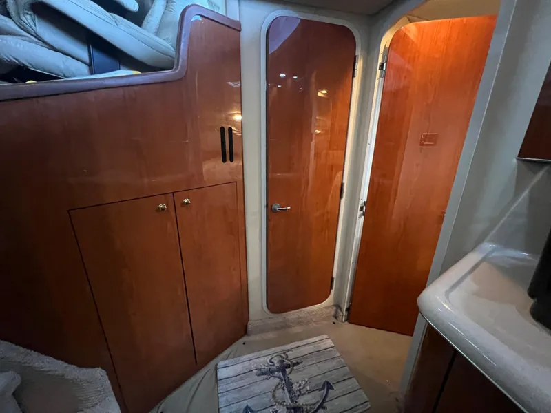 Slide: The Image of Interior of 2000 Sea Ray 380 Aft Cabin with wooden cabinetry and doors. - 22