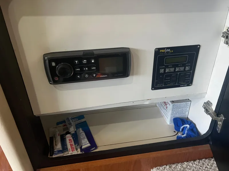 Slide: The Image of Control panel and storage inside 2000 Sea Ray 380 Aft Cabin yacht. - 27