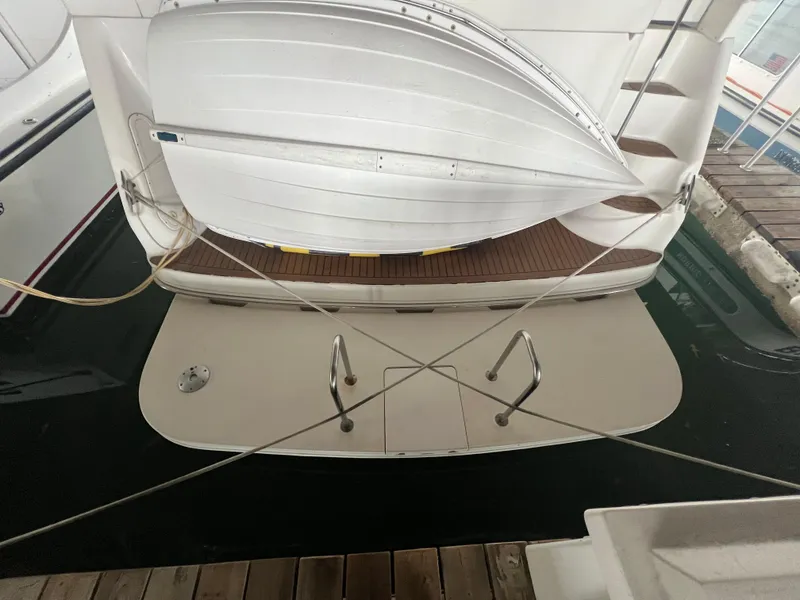 Slide: The Image of Sea Ray 380 Aft Cabin 2000 with swim platform and dinghy, docked at marina. - 28