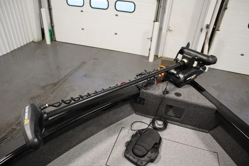 Slide: The Image of 2025 Crestliner 1850 Super Hawk JS boat interior with trolling motor in garage. - 11