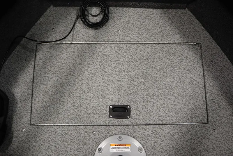 Slide: The Image of 2025 Crestliner 1850 Super Hawk JS boat interior with carpeted floor and storage compartment. - 15