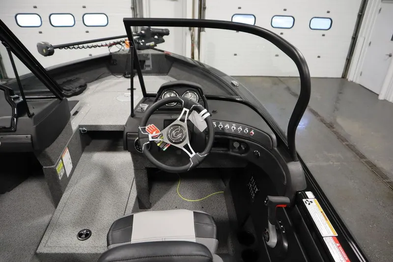 Slide: The Image of 2025 Crestliner 1850 Super Hawk JS boat interior with steering wheel and control panel. - 22