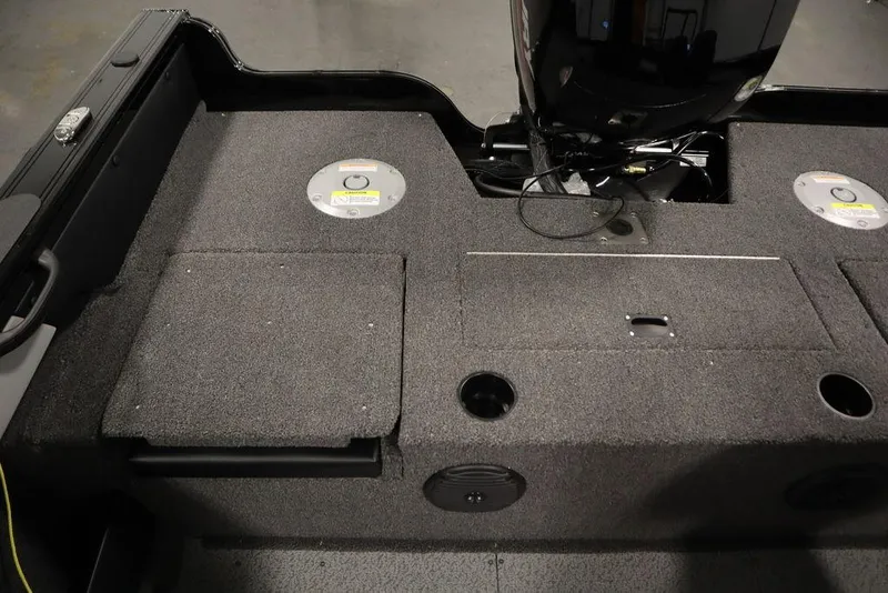 Slide: The Image of Crestliner 1850 Super Hawk JS 2025 boat interior with carpeted deck and storage compartments. - 34