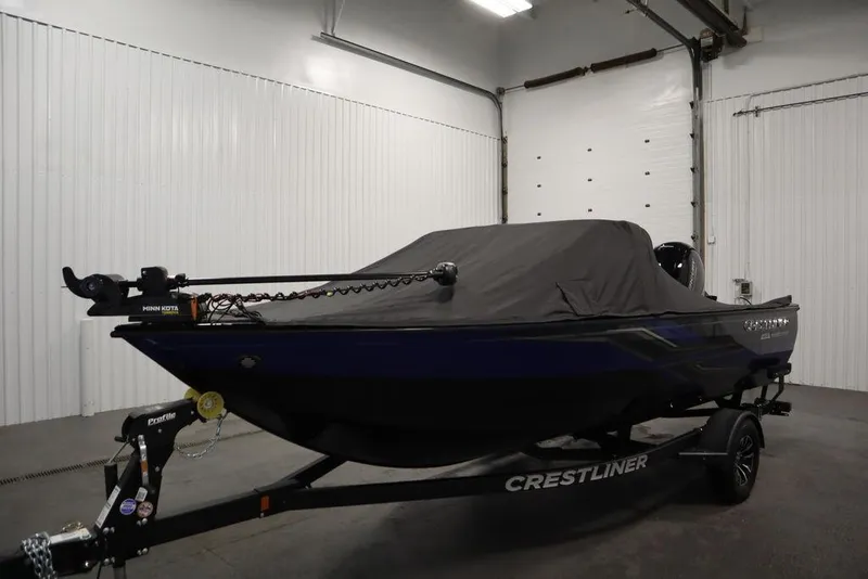 Slide: The Image of 2025 Crestliner 1850 Super Hawk JS boat with cover in a garage. - 45
