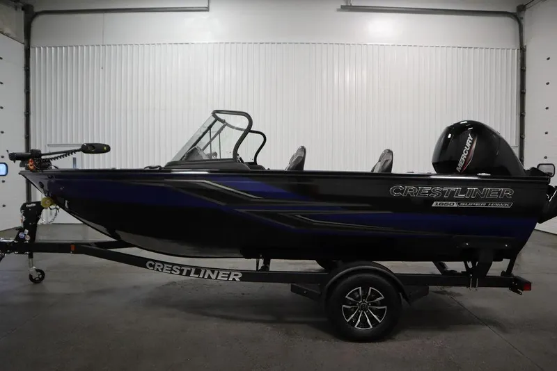 Slide: The Image of 2025 Crestliner 1850 Super Hawk JS boat in showroom, side view. - 8