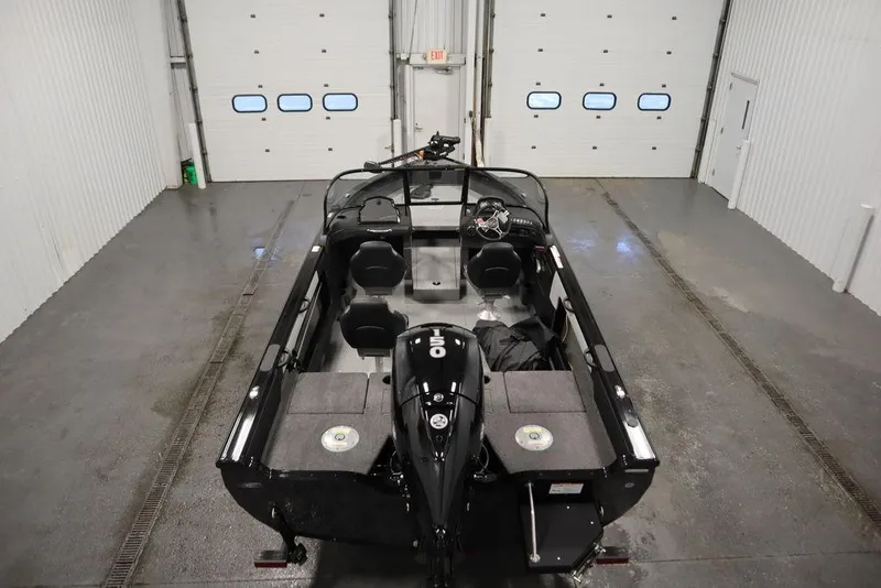 Slide: The Image of 2025 Crestliner 1850 Super Hawk JS boat in a spacious indoor garage. - 9
