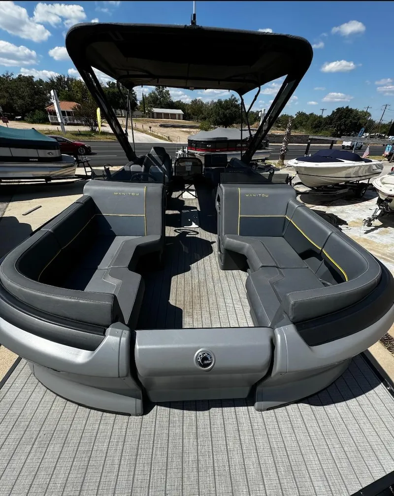Slide: The Image of 2024 Manitou Explore pontoon boat with spacious seating and modern design. - 6