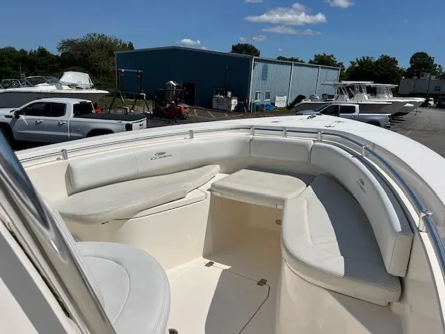 Slide: The Image of 2021 Cobia 237 Center Console boat with spacious seating area, parked outdoors. - 16