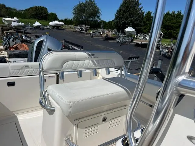 Slide: The Image of 2021 Cobia 237 Center Console boat interior with white seating and chrome details. - 17