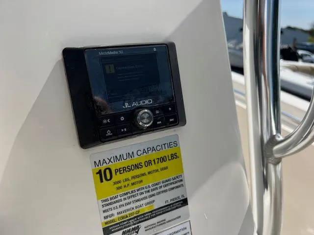 Slide: The Image of 2021 Cobia 237 Center Console boat with JL Audio system and capacity label. - 20