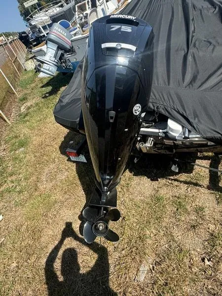 Slide: The Image of 2022 Tahoe T16 with Mercury 75 outboard motor, parked on grass. - 3