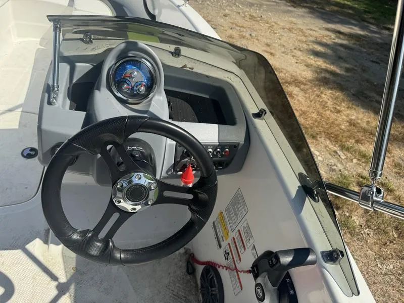 Slide: The Image of 2022 Tahoe T16 boat dashboard with steering wheel and controls. - 4
