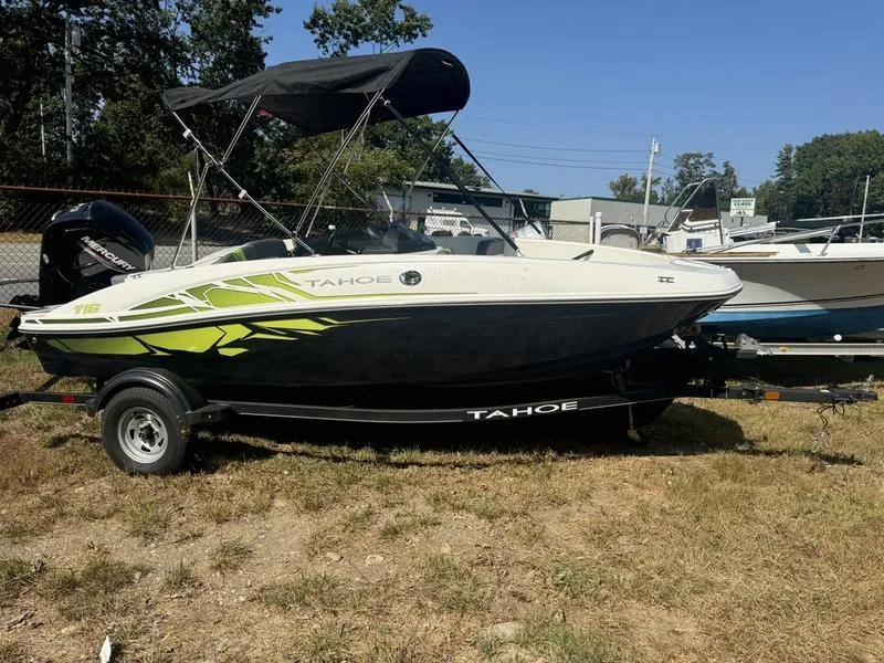 Slide: The Image of 2022 Tahoe T16 boat with canopy on trailer, parked on grass. - 6