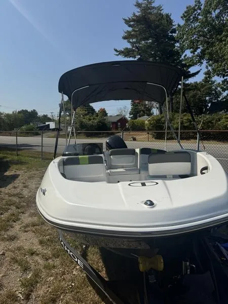 Slide: The Image of 2022 Tahoe T16 boat with canopy, parked outdoors on grass. - 8